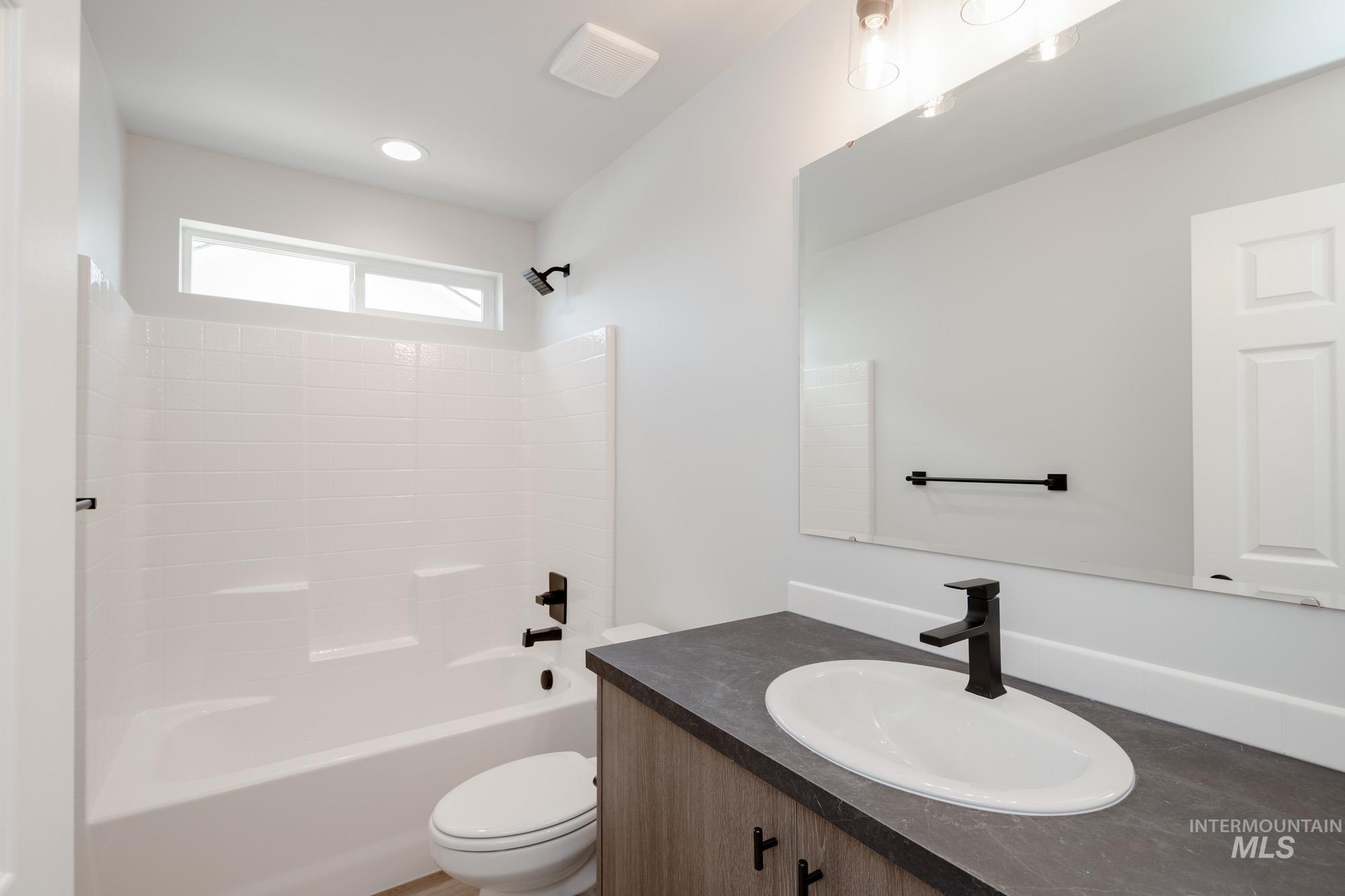 Full bathroom with vanity and bathing tub / shower combination