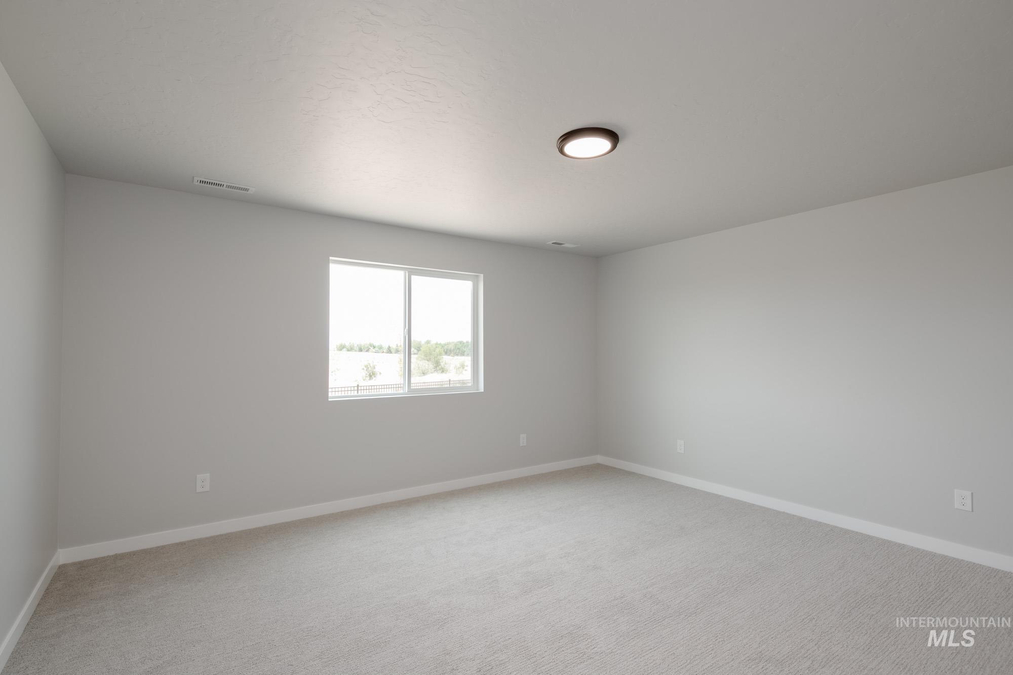 Unfurnished room featuring light colored carpet