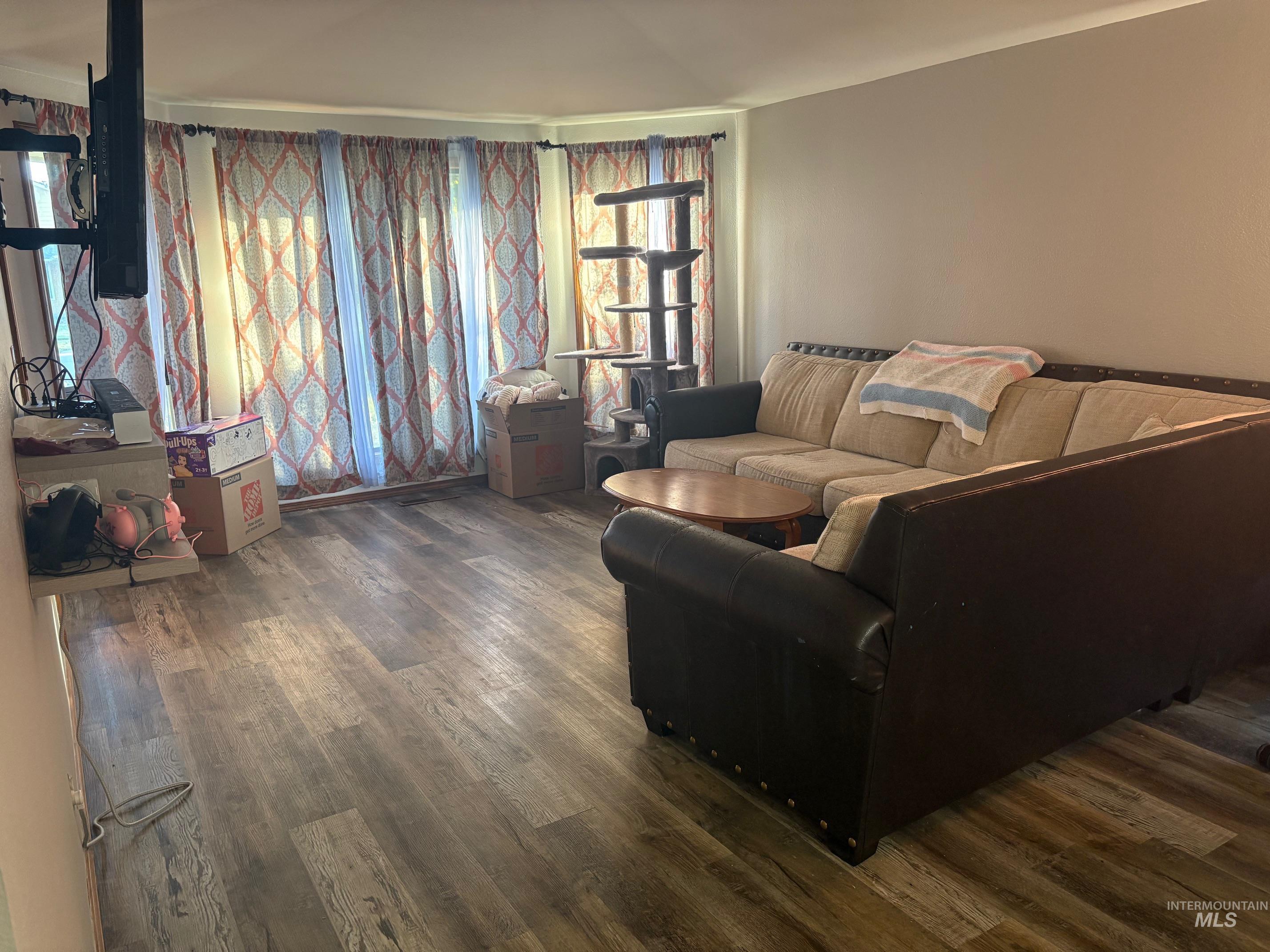 Living area with dark wood-style flooring