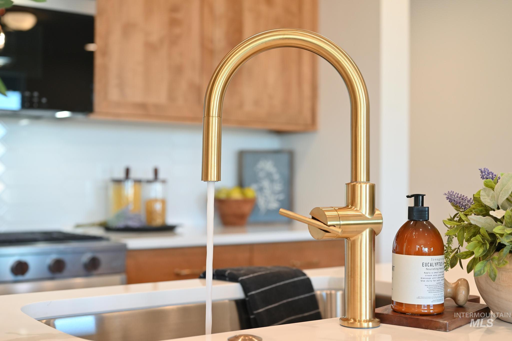 Kitchen view of a sink and stainless steel range with gas cooktop