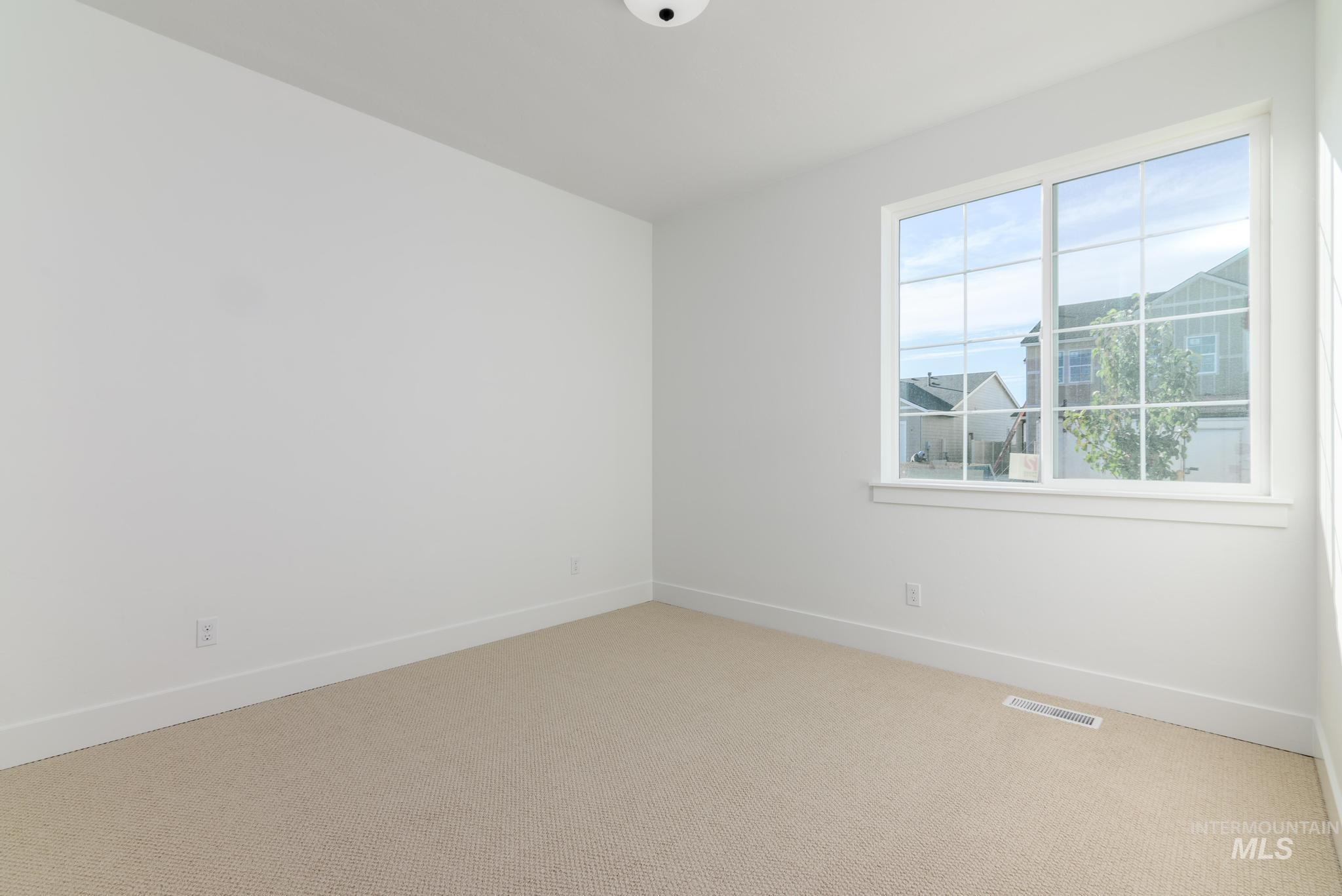 Empty room with baseboards and carpet flooring