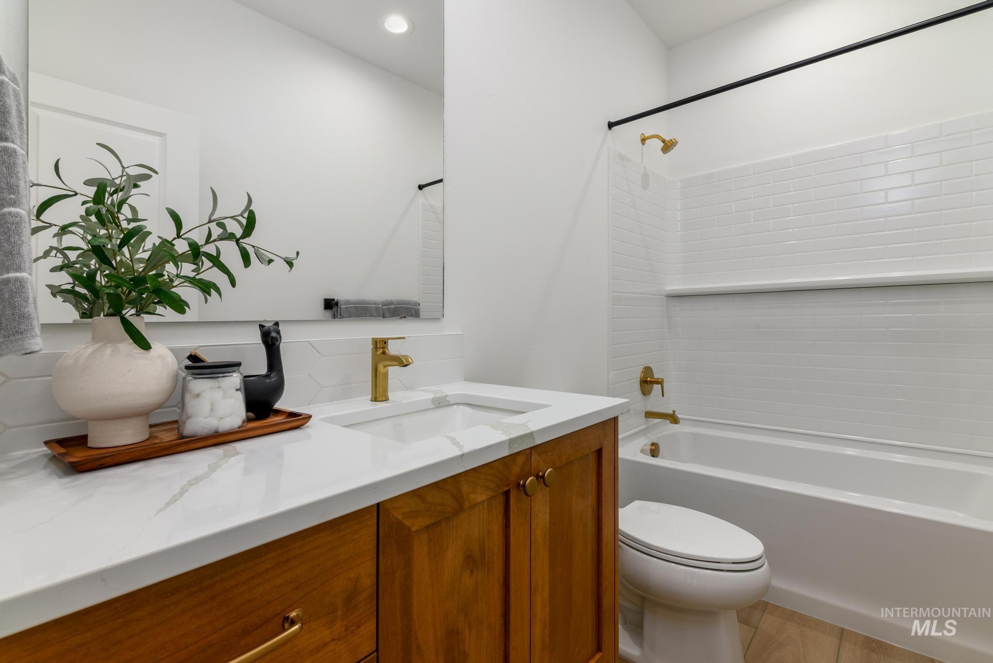 Full bathroom with vanity, shower / bath combination, and recessed lighting