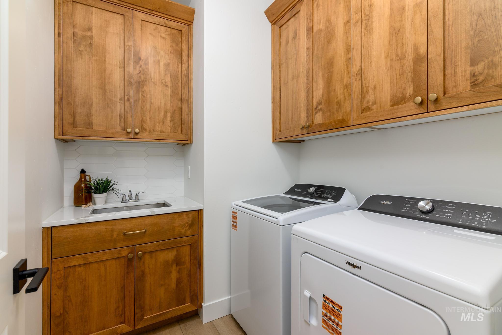 Laundry area with cabinet space and separate washer and dryer