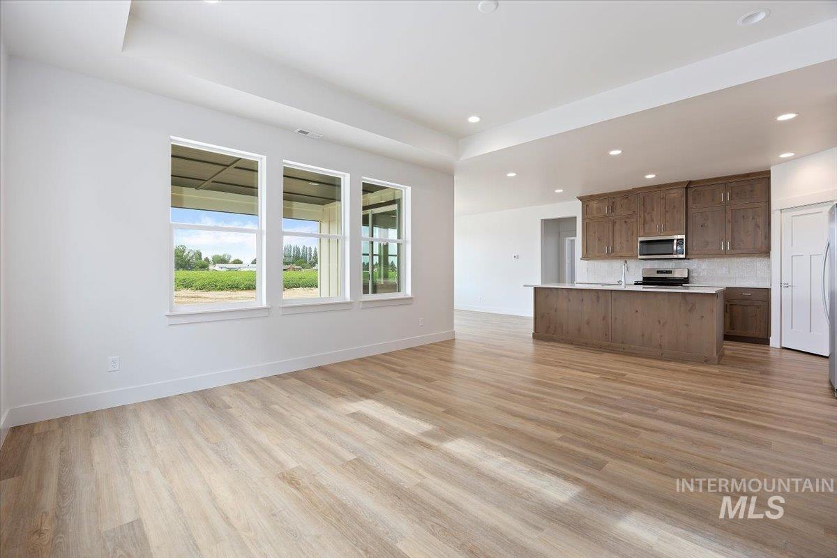 Unfurnished living room with light wood-style floors and recessed lighting
