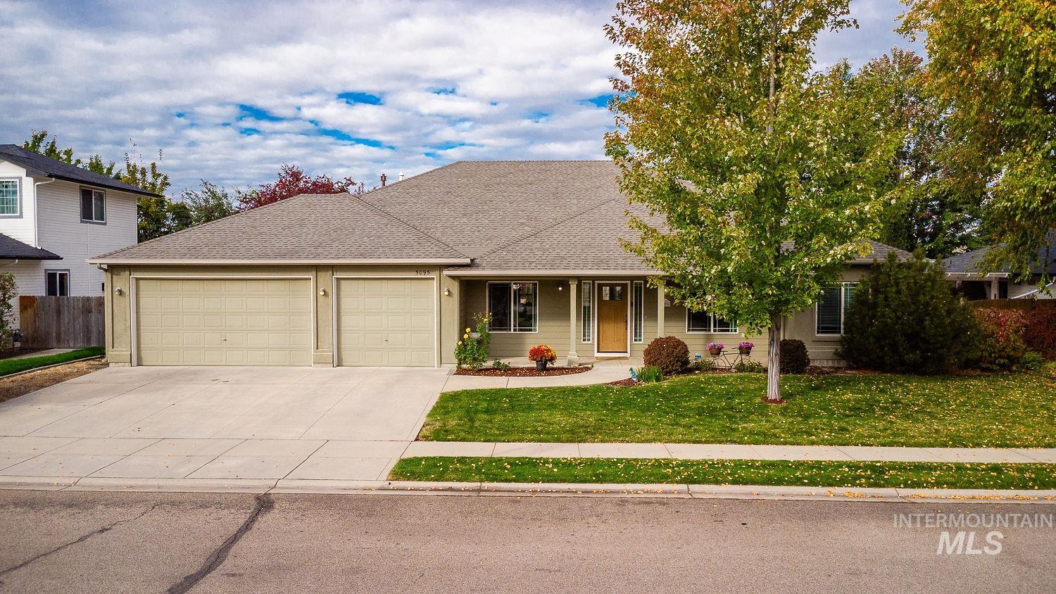 Ranch-style house with a shingled roof, covered porch, driveway, and a garage