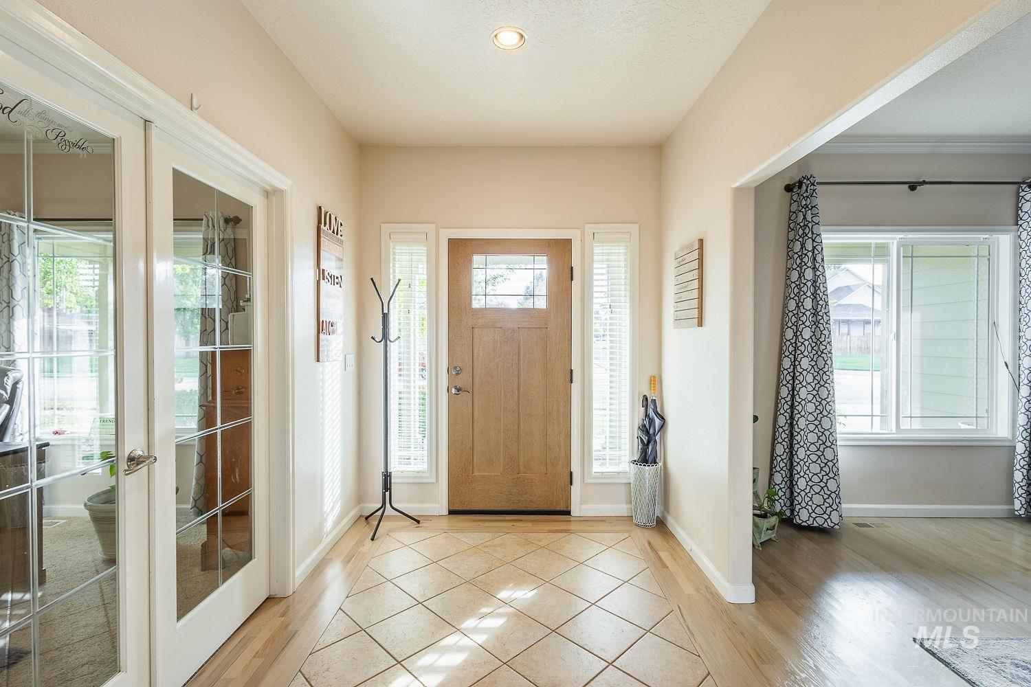 Foyer entrance with light wood-type flooring, recessed lighting, and french doors