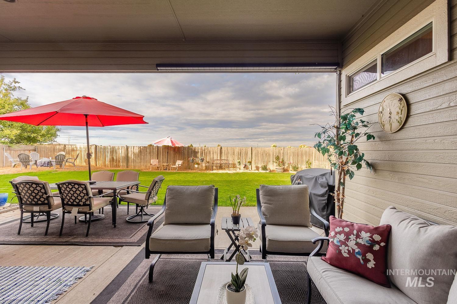 Fenced backyard featuring outdoor dining area, a patio area, grilling area, and an outdoor hangout area