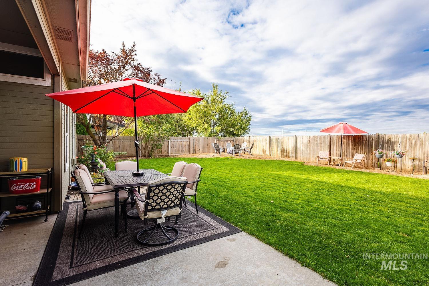 Fenced backyard featuring a patio and outdoor dining area