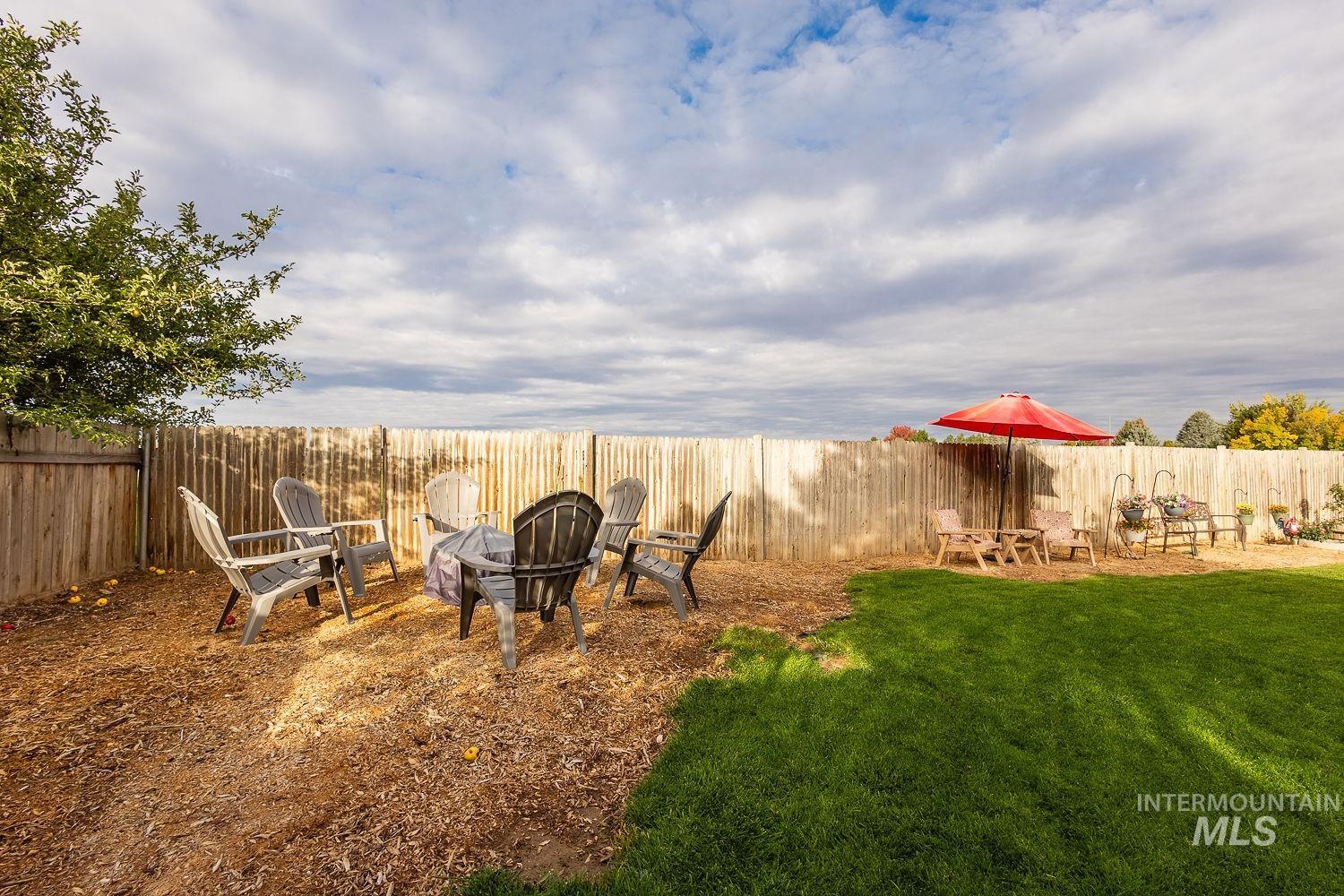 Fenced backyard featuring a fire pit