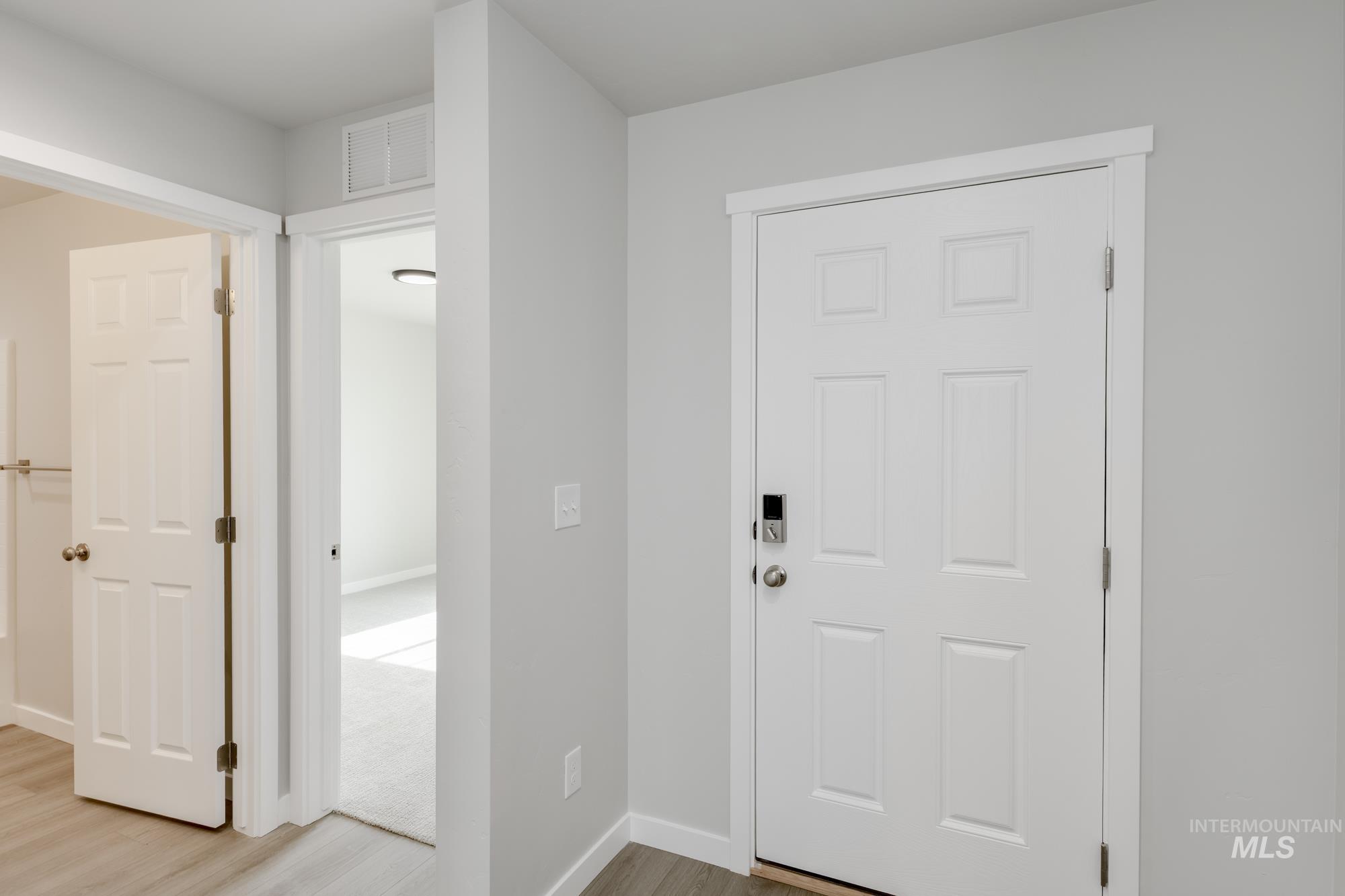 Entryway with light wood-style floors and baseboards