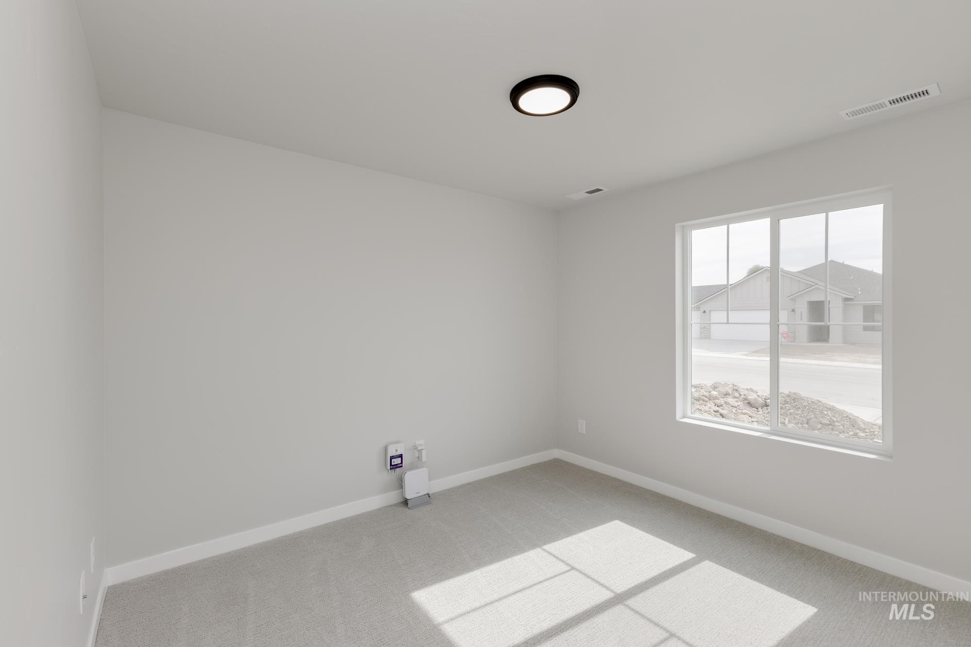 Carpeted empty room with baseboards