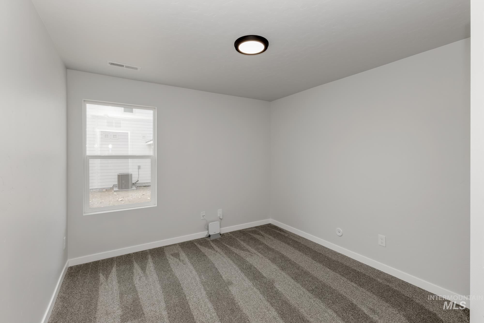 Unfurnished room with carpet floors and baseboards