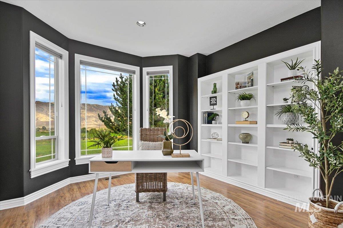 Office space with healthy amount of natural light, wood finished floors, recessed lighting, and a mountain view