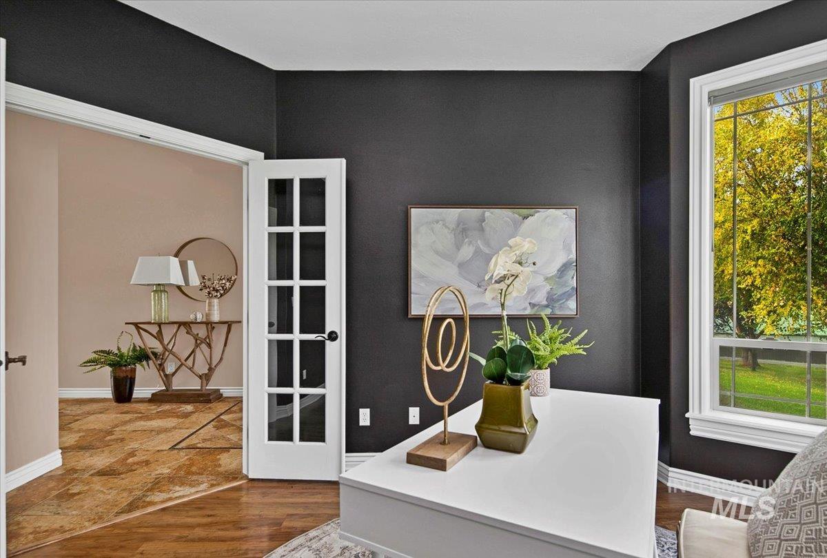 Office space with baseboards and dark wood-style flooring
