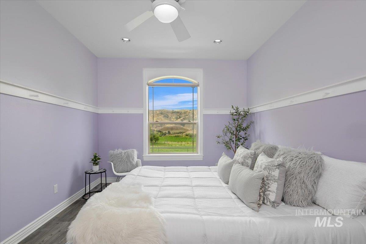 Bedroom with a ceiling fan, wood finished floors, and recessed lighting
