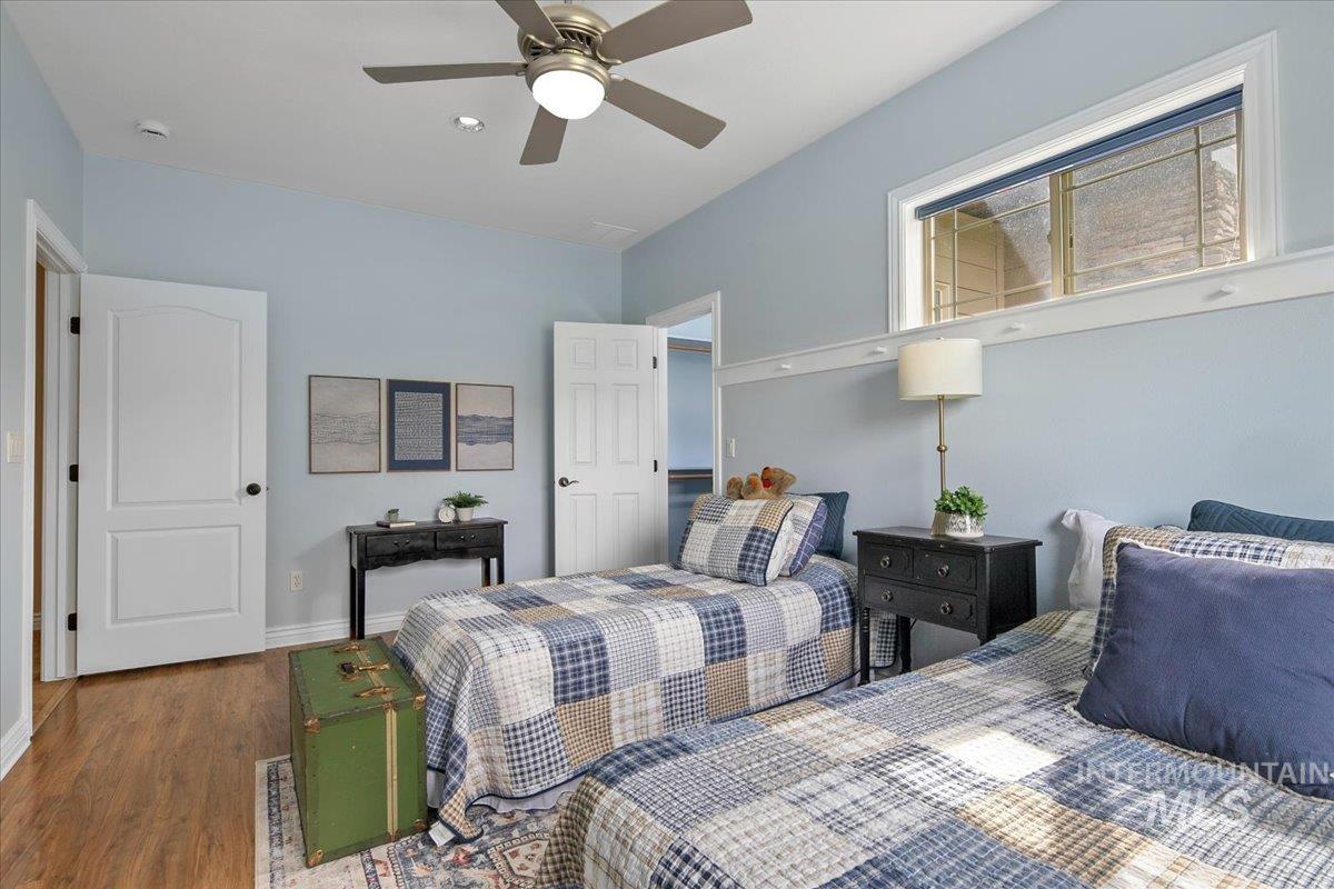 Bedroom featuring wood finished floors and ceiling fan