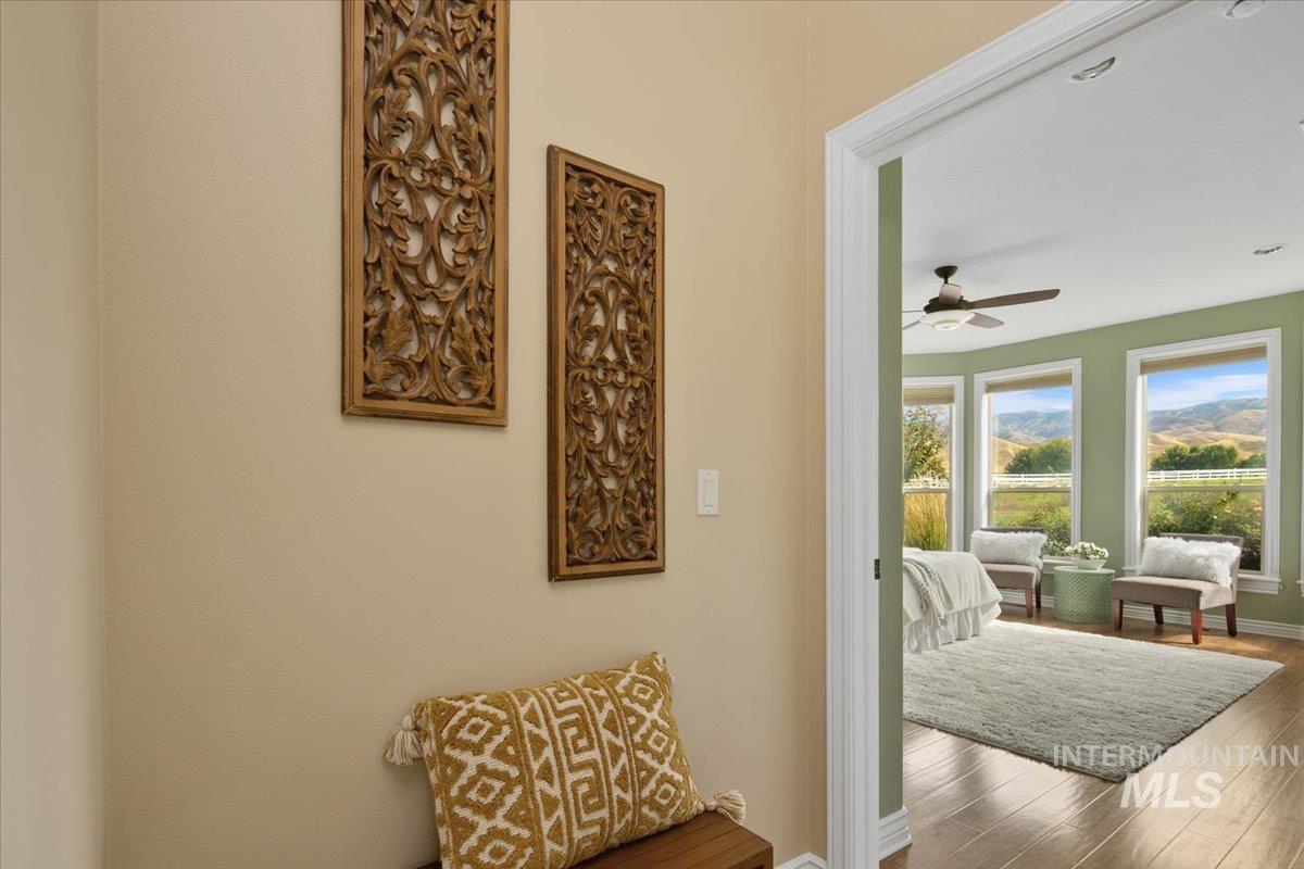 Doorway featuring wood finished floors and a ceiling fan