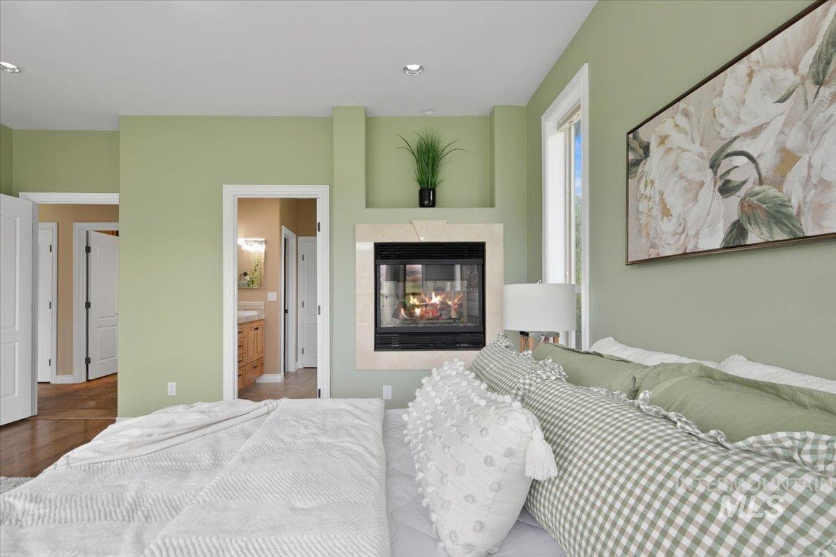 Bedroom with a premium fireplace and ensuite bath