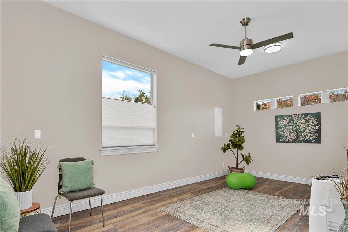 Exercise area featuring wood finished floors and ceiling fan