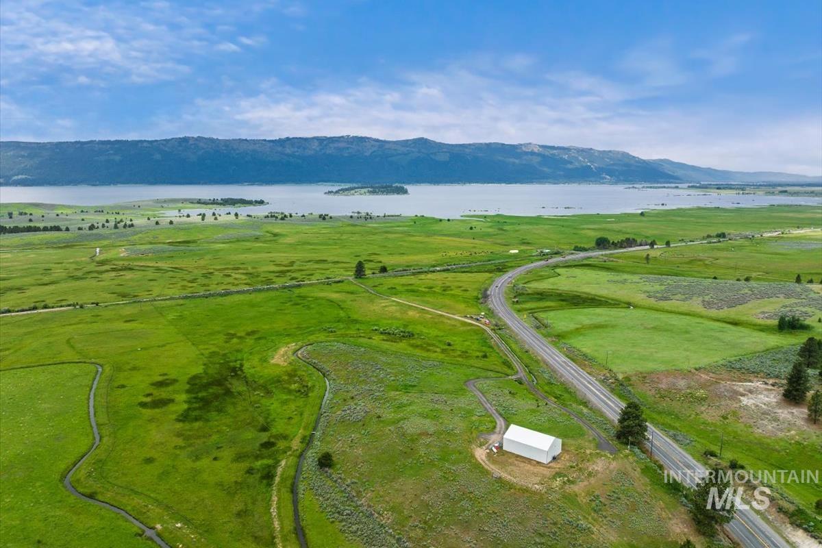 View of rural area with a water and mountain view and a pastoral area