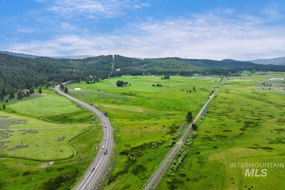 Bird's eye view of a heavily wooded area and a mountainous background