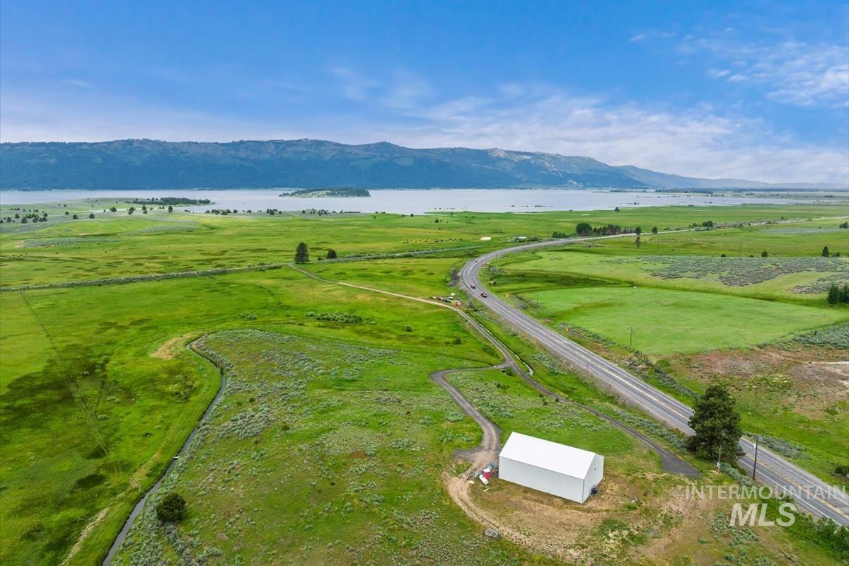 View of rural area featuring a water and mountain view and agricultural land