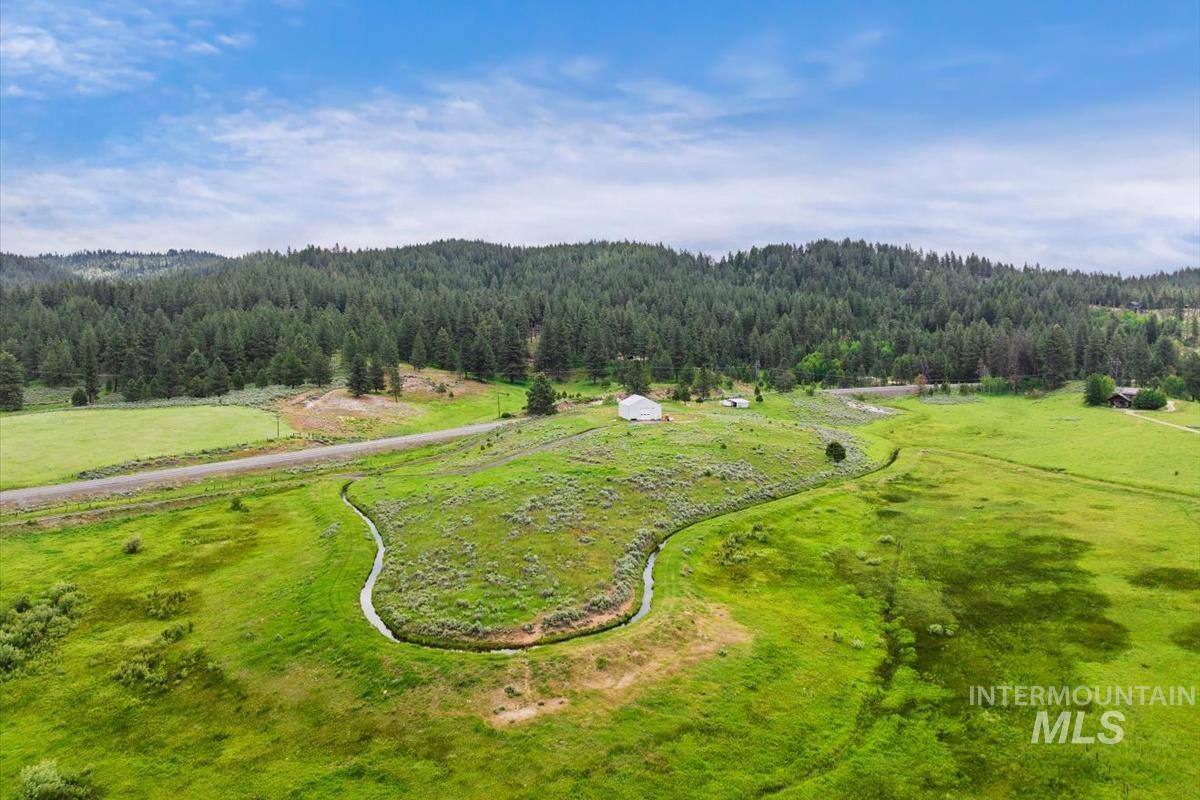 Overview of rural landscape featuring a heavily wooded area
