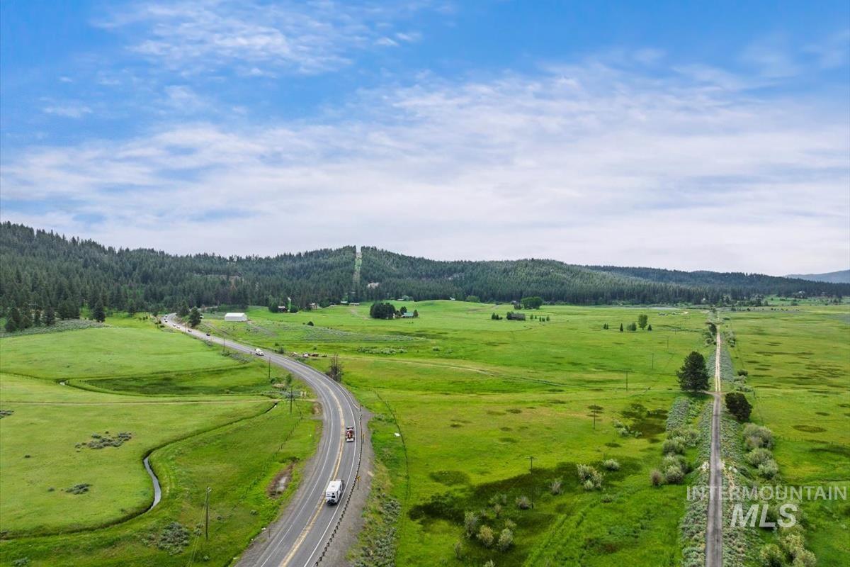 Drone / aerial view of a major roadway and a mountainous background