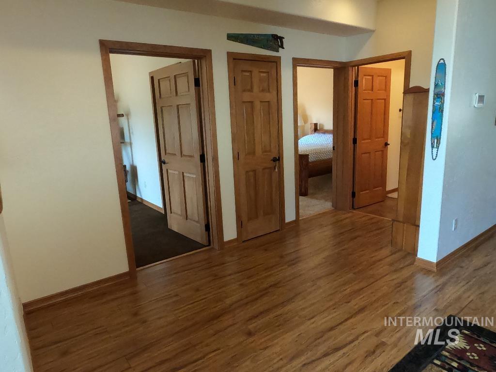 Empty room featuring wood finished floors and baseboards