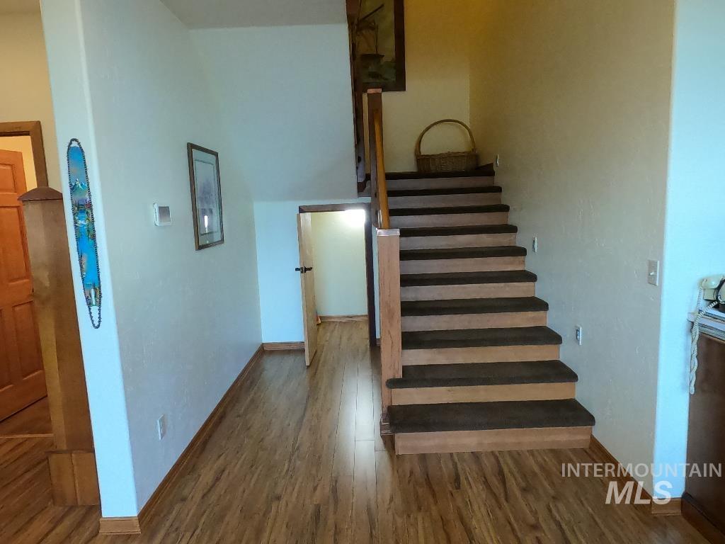 Stairway featuring wood finished floors and baseboards