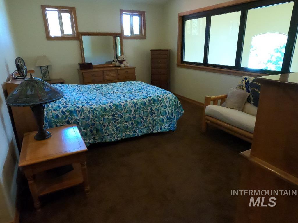 Bedroom featuring baseboards and carpet floors