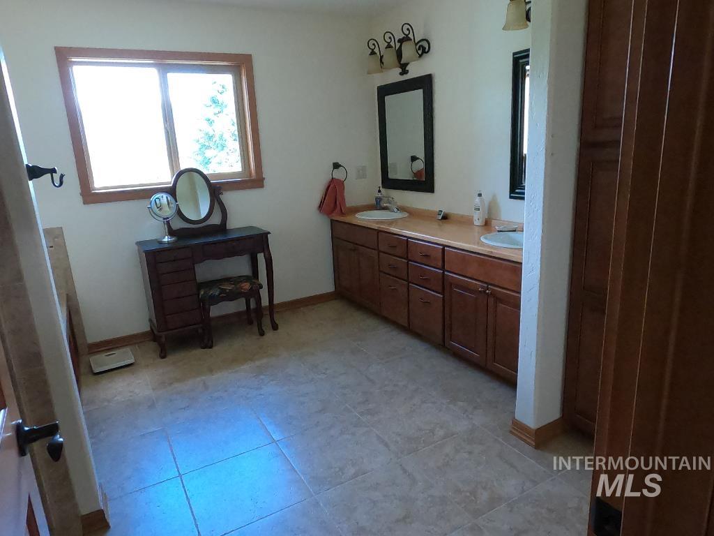 Bathroom with double vanity and tile patterned flooring