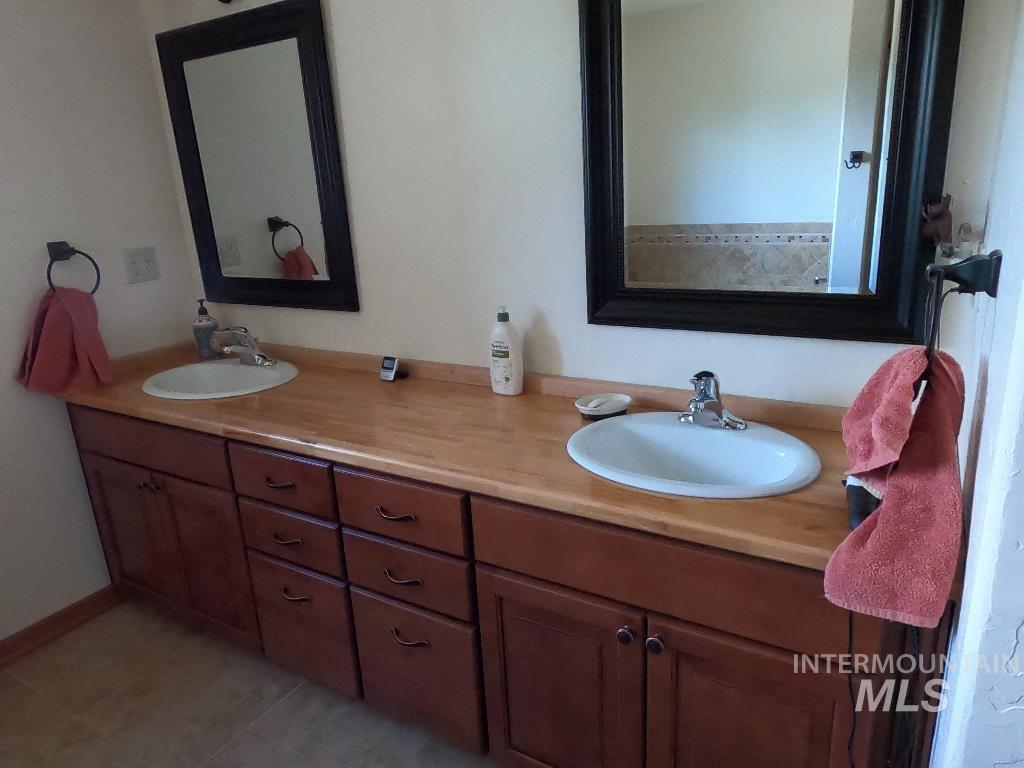 Bathroom featuring double vanity and tile patterned floors