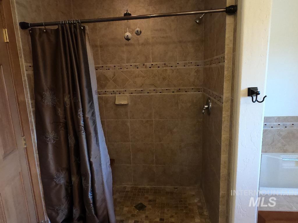 Full bathroom with a tile shower