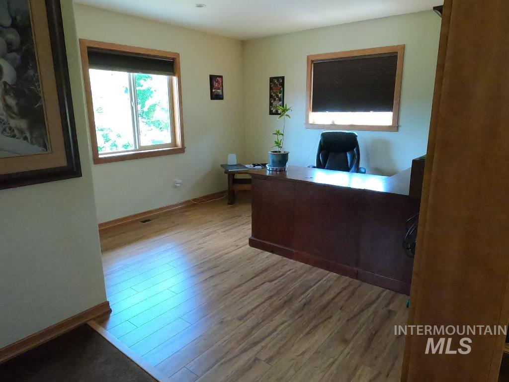 Home office with wood finished floors
