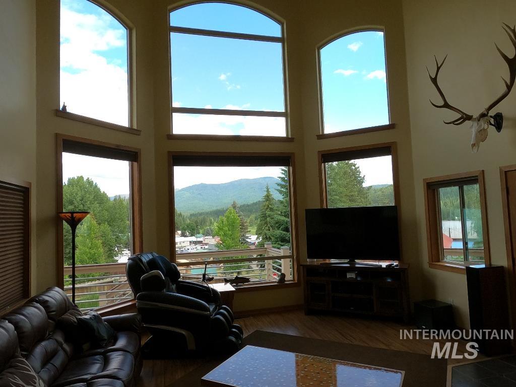 Living room with a high ceiling and wood finished floors