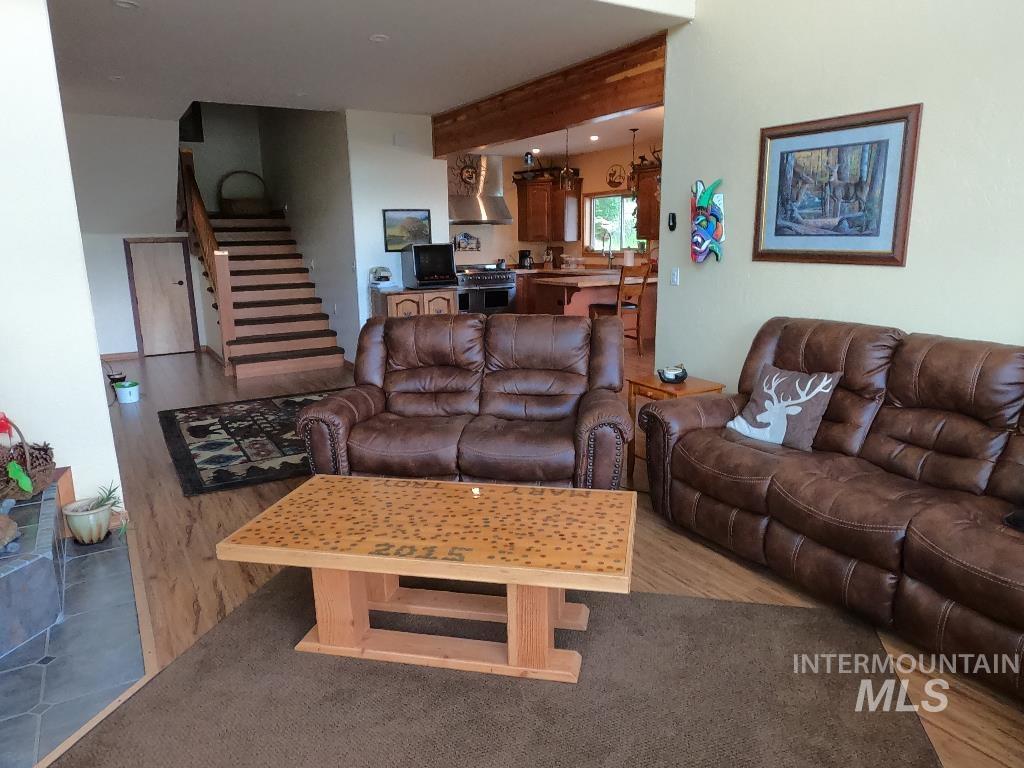 Living area with stairs and light wood finished floors