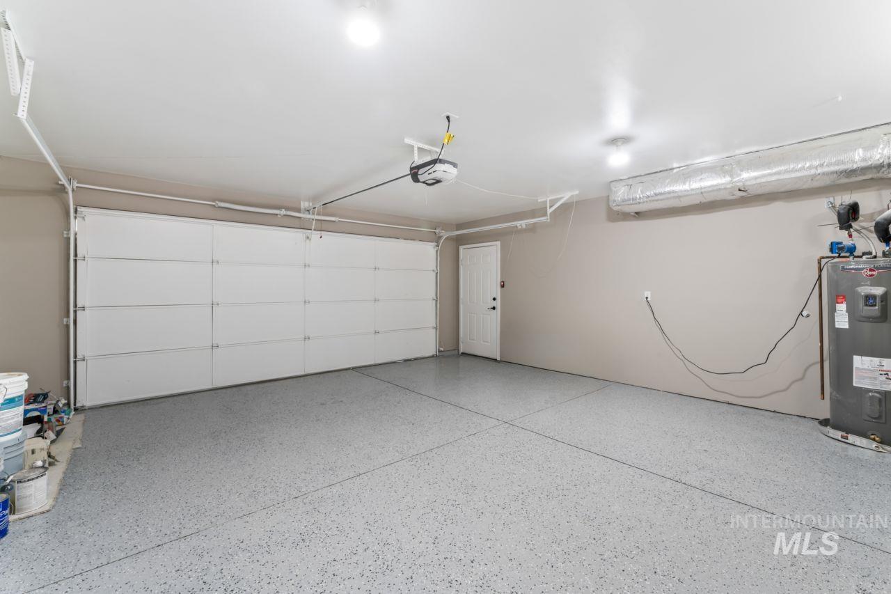 Garage with electric water heater and a garage door opener