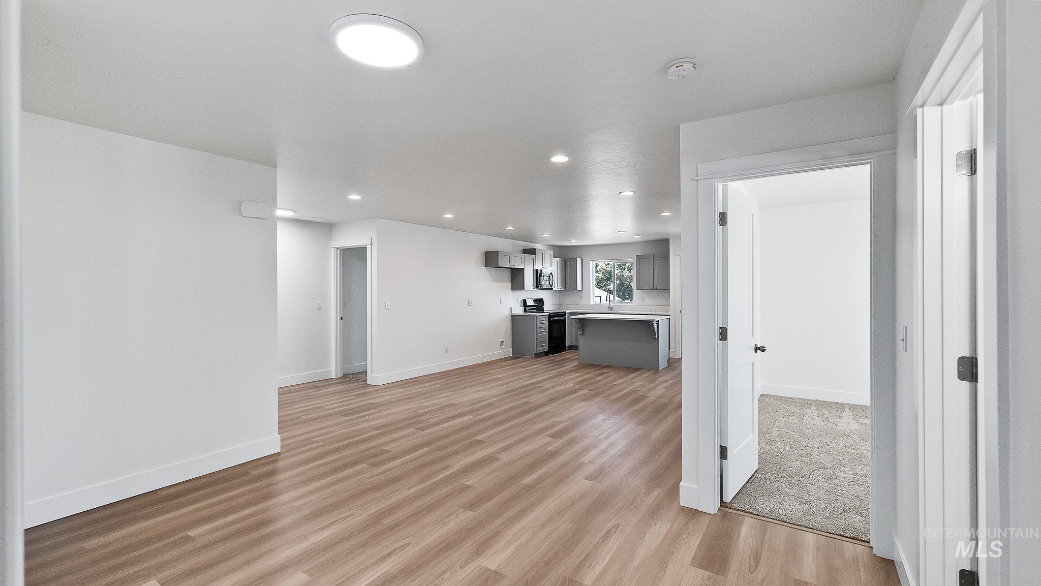 Unfurnished living room featuring recessed lighting and light wood-style flooring