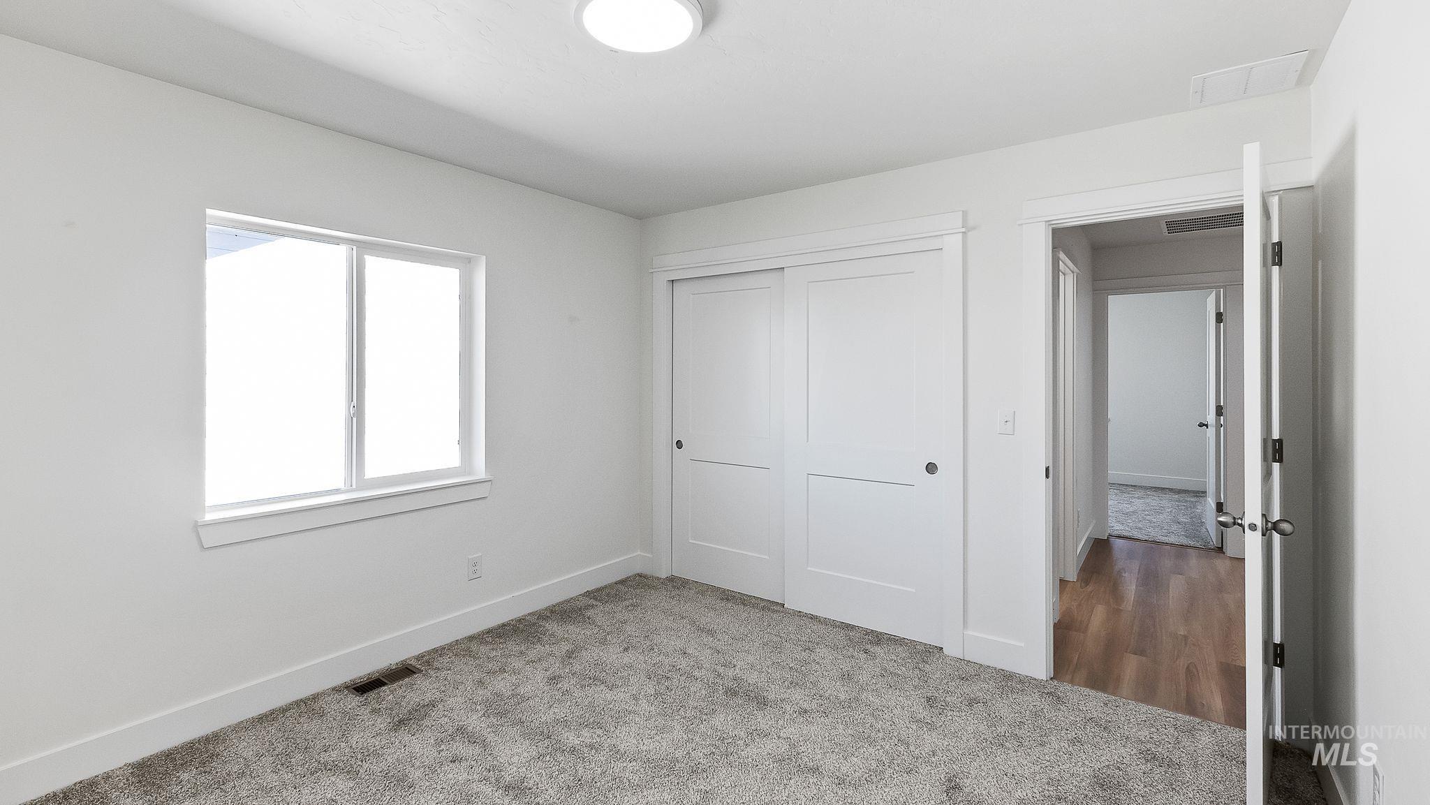 Unfurnished bedroom with carpet and a closet
