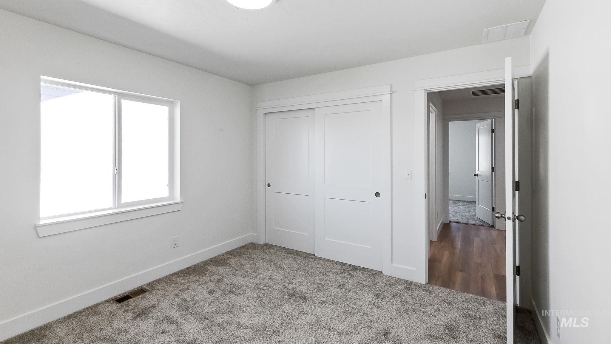 Unfurnished bedroom with carpet floors and a closet