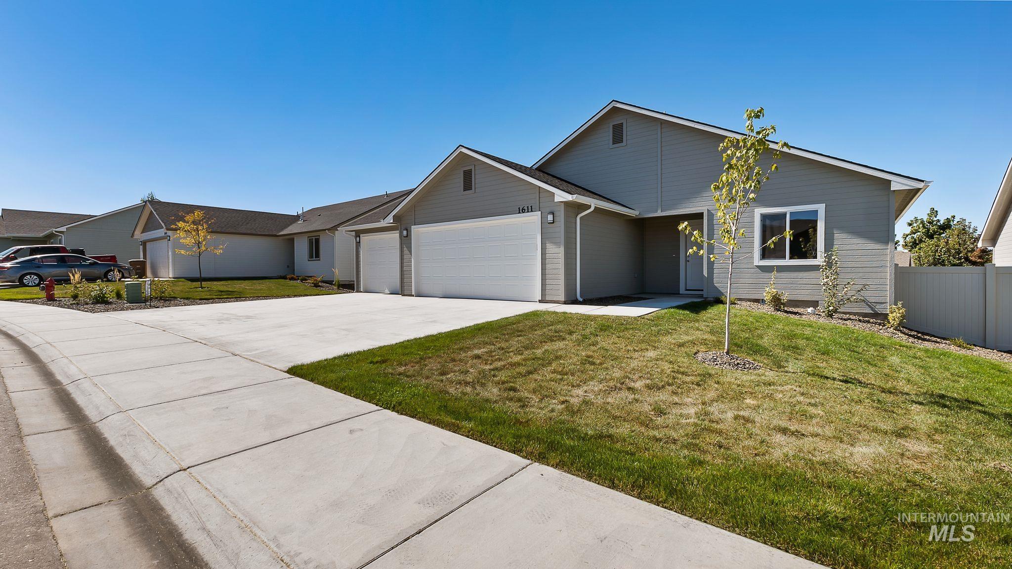 Single story home featuring a garage and concrete driveway