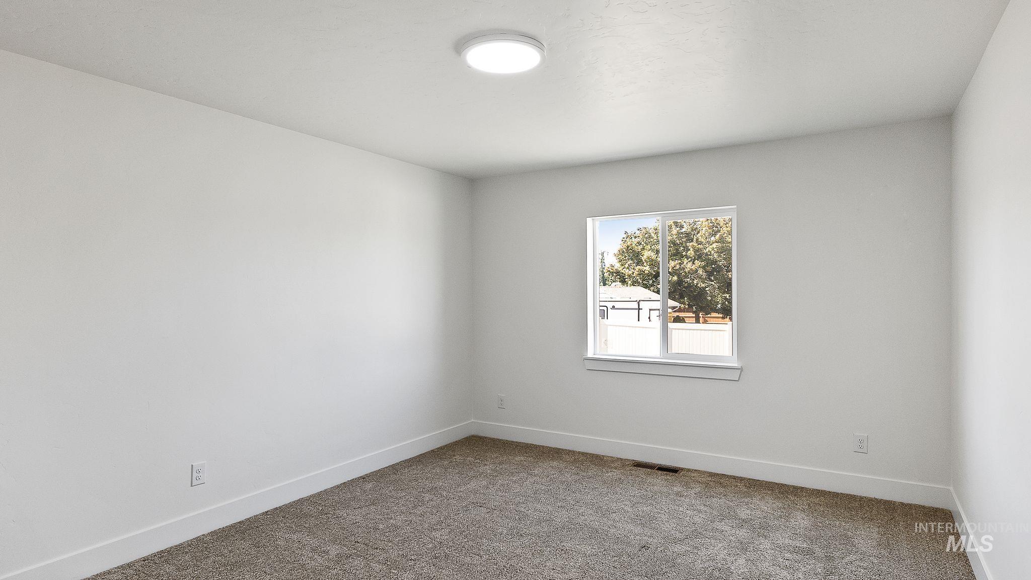 Unfurnished room featuring carpet and baseboards