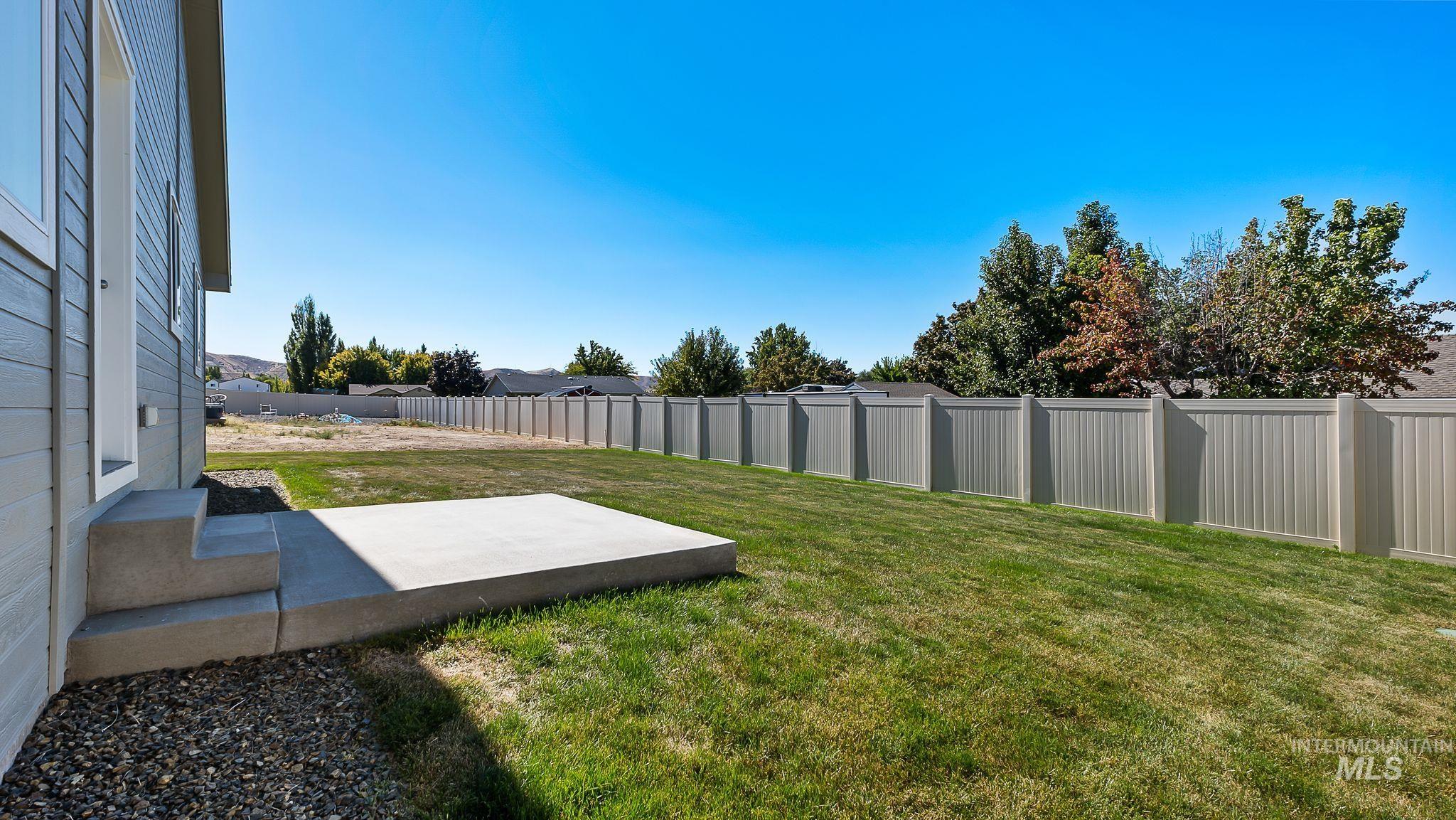 Fenced backyard with a patio