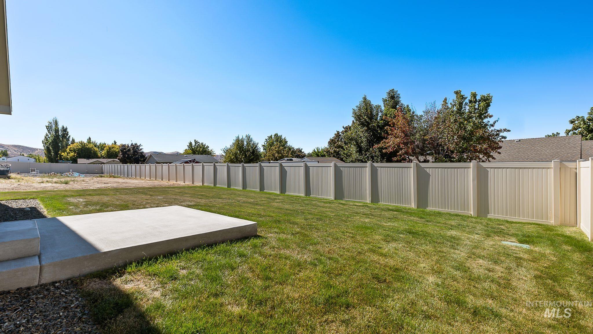 Fenced backyard with a patio area