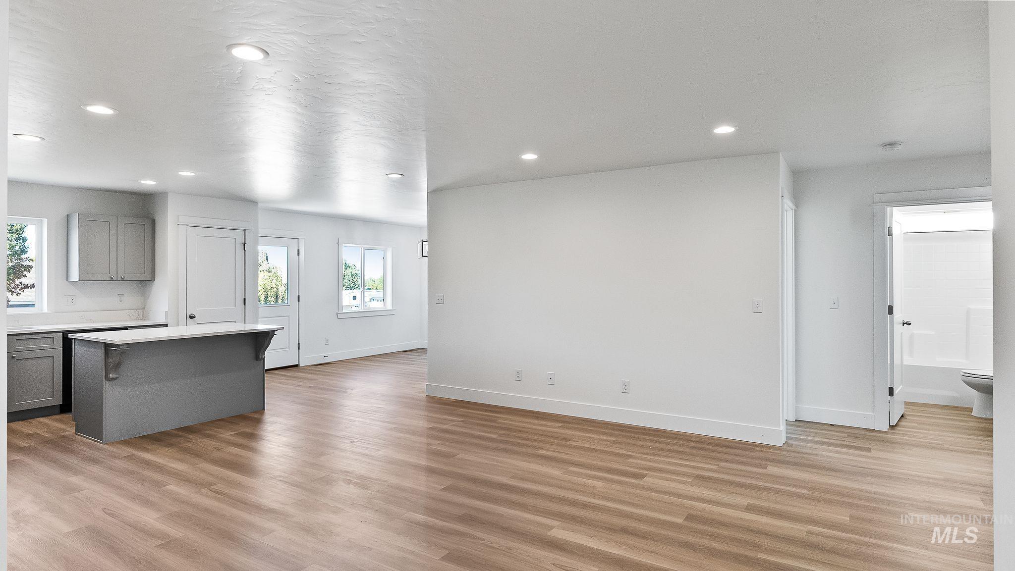 Unfurnished living room featuring light wood-style flooring and recessed lighting