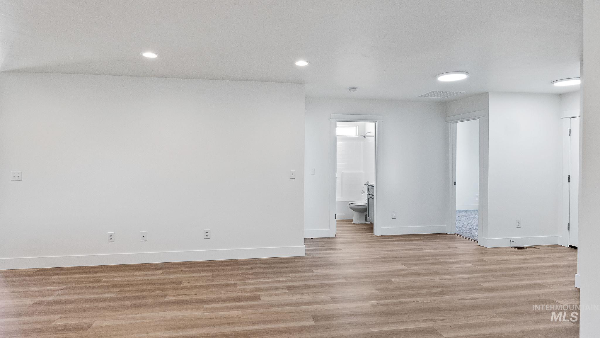 Spare room with light wood finished floors and recessed lighting