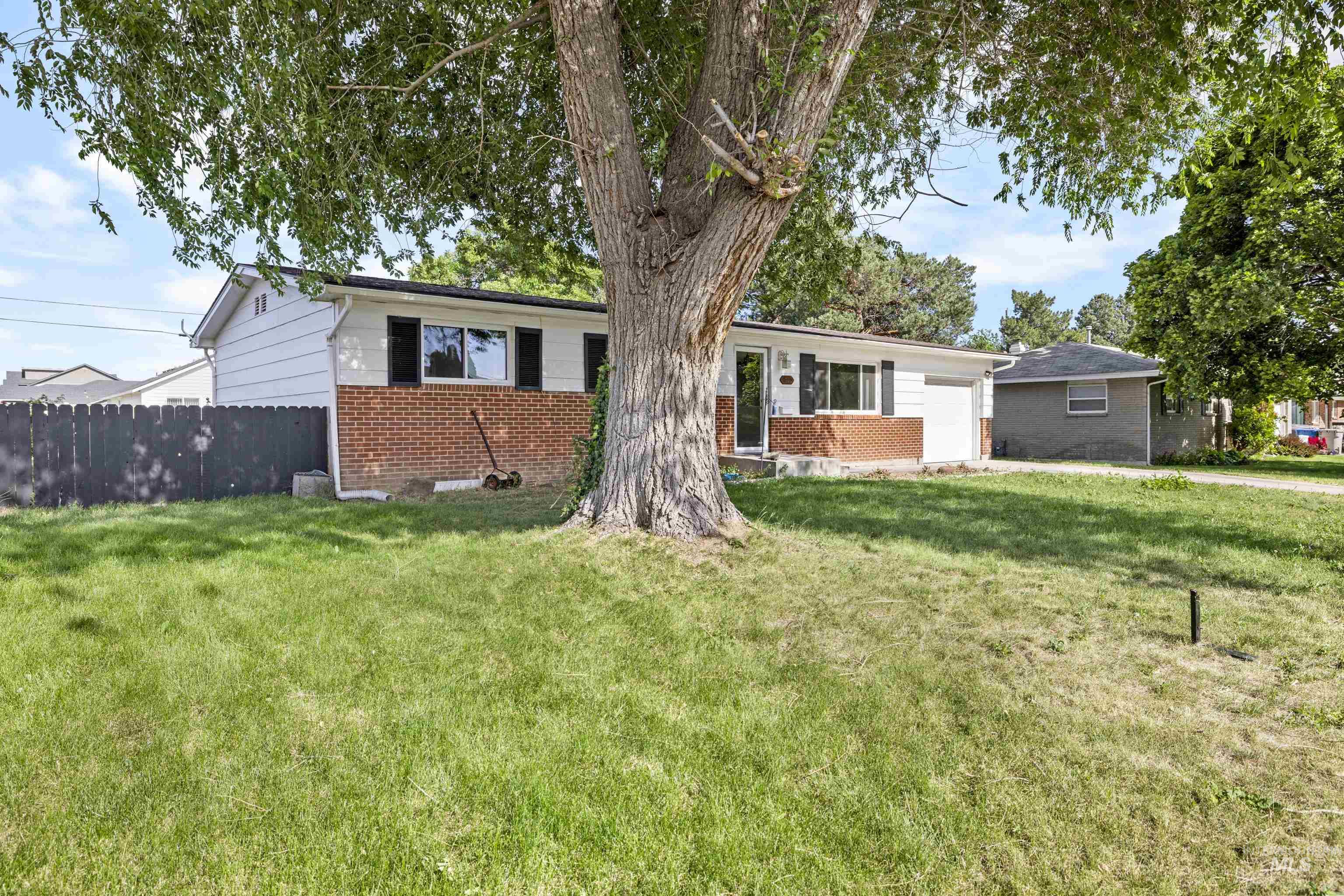 Ranch-style house with brick siding and an attached garage
