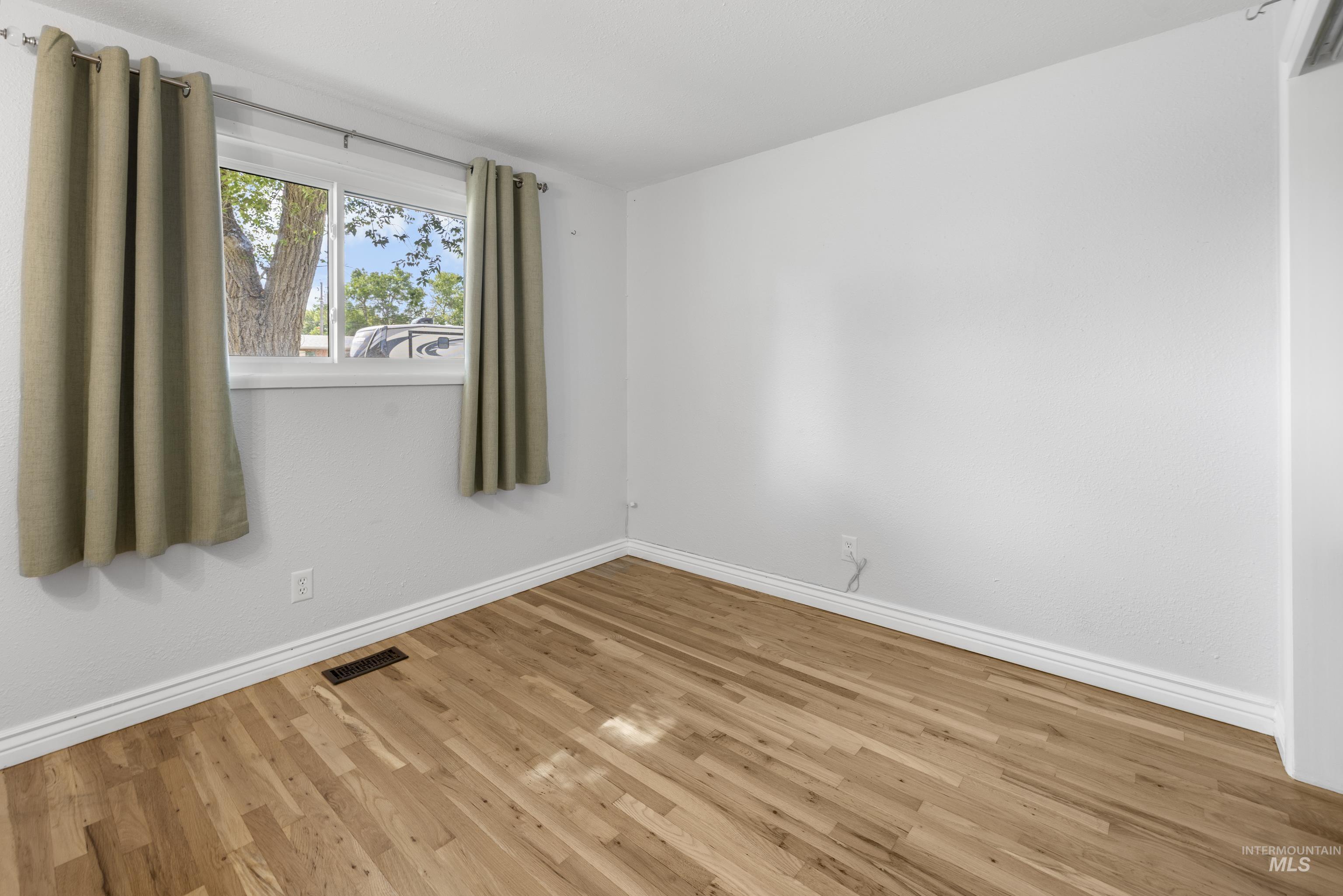 Spare room with wood finished floors