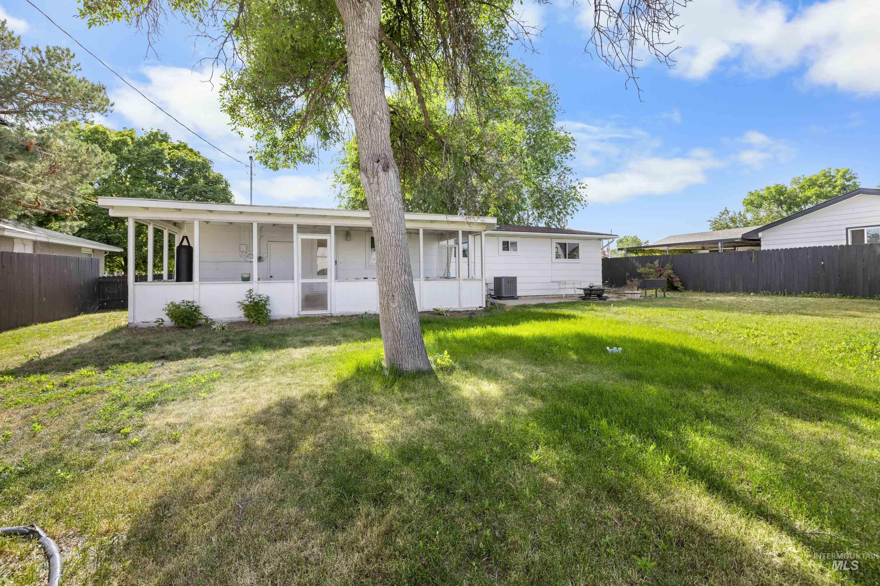 Rear view of property with a sunroom and a fenced backyard